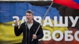 Boris Nemtsov, a former Russian deputy prime minister and opposition leader addresses demonstrators during a massive rally to oppose president Vladimir Putin's policies in Ukraine, in Moscow, Saturday, March 15, 2014. 