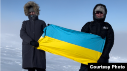 Nikita Gorbunov (right) is under investigation on suspicion of "discrediting the armed forces of the Russian Federation" for holding a sign reading, "Hug me if you are against the war."