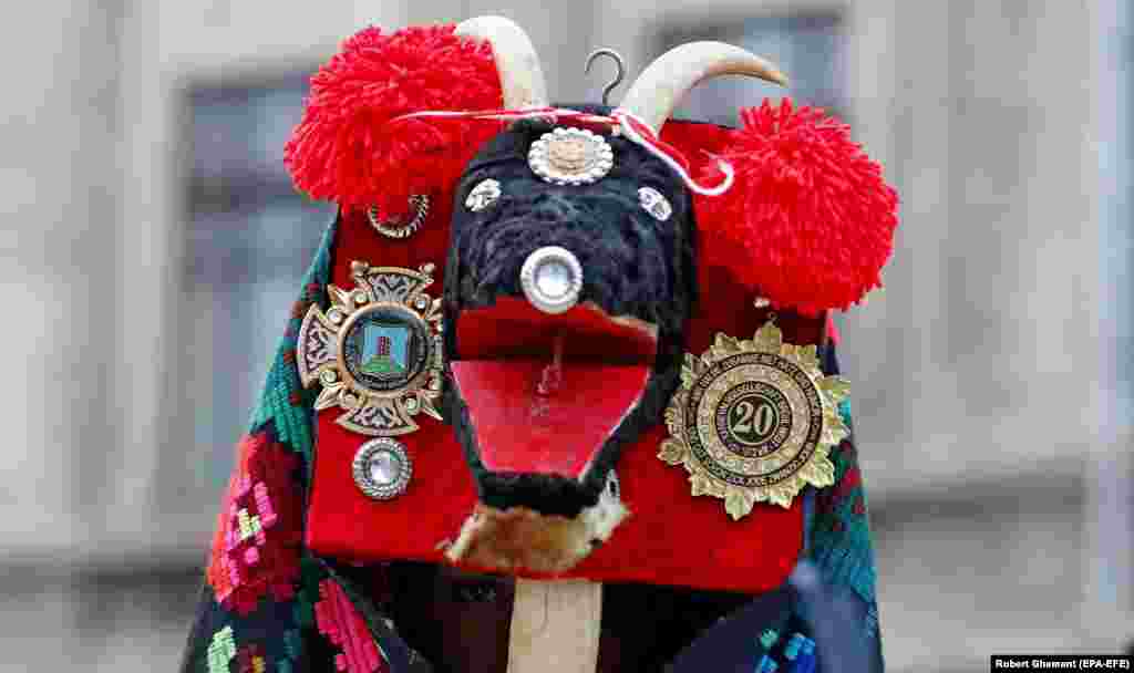 A man peers out from under his &quot;goat&quot; mask as the festival&#39;s parade begins.&nbsp;