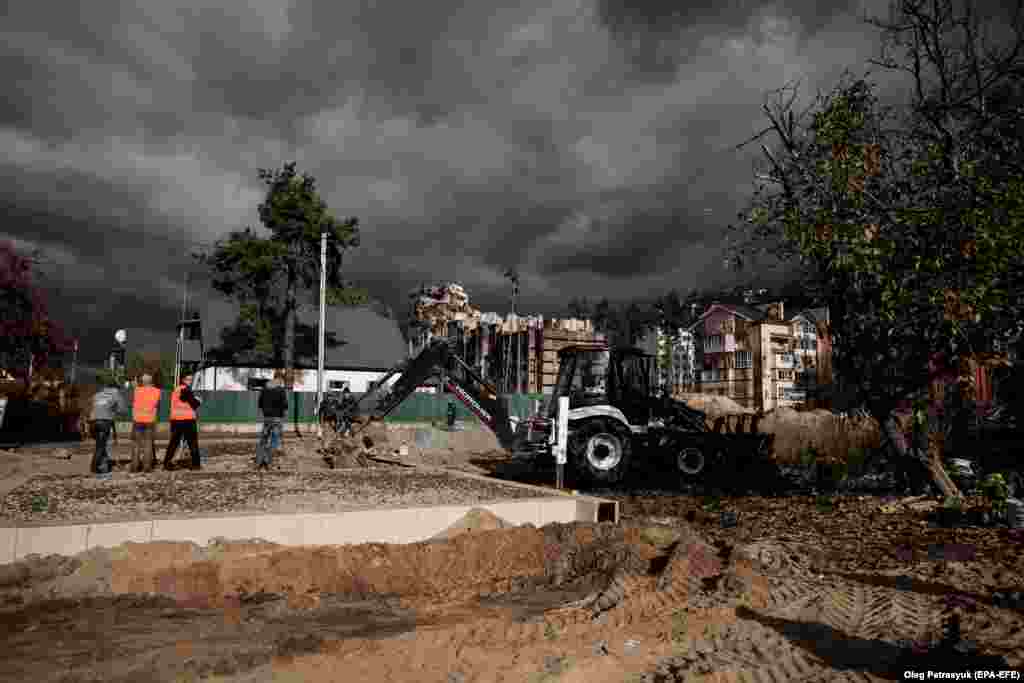 Workers at the construction site. Authorities have&nbsp;designated Irpin as a &quot;hero city,&quot; an acknowledgement of the resolve its people have demonstrated in the face of so much adversity.