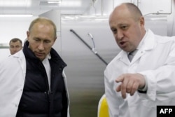 Prigozhin -- known as "Putin's chef" -- with then-Russian Prime Minister Vladimir Putin at his school lunch factory outside St. Petersburg in September 2010.