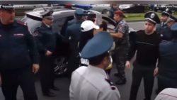 Police detaining protesters in Yerevan on May 11