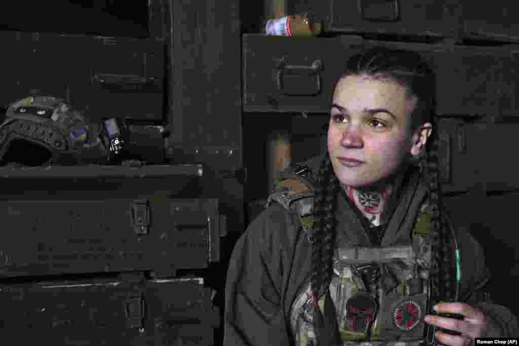 A Ukrainian soldier plays with her braids as she rests in a shelter on March 18. As the Russian assaults intensify, there have been high rates of casualties on both sides.