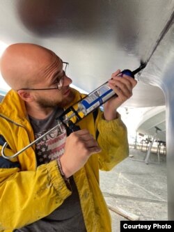 Vesnin repairing the hull of the Oikumena.