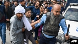 Police detain supporters of Pakistan's former Prime Minister Imran Khan in Islamabad on March 18.