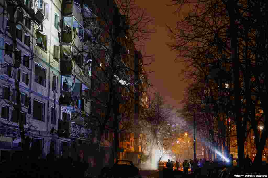 Emergency staff work at the site of the attack that struck an apartment building. Falling debris caused injuries and destruction in four of Kyiv&#39;s districts along the Dnieper River, which cuts through the capital, officials said.
