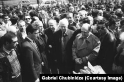 A memorial event in 1992 or 1993 attended by Eduard Shevardnadze (center, with white hair), a Soviet then Georgian politician who came to power following the 1991-92 coup. The photo, which is published here for the first time, shows Shevardnadze alongside notorious Georgian coup leaders Jaba Ioseliani (center left in black coat) and Tengiz Kitovani (front right).