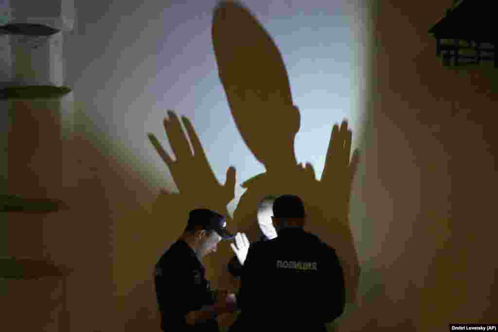 Police officers check the documents of a man in central Moscow.