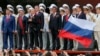 Russian President Vladimir Putin (third left) makes a speech standing with Crimean parliamentary speaker Vladimir Konstantinov (second left), then-Crimean Prime Minister Sergei Aksyonov (fourth left) and other top officials in Sevastopol in 2014. 