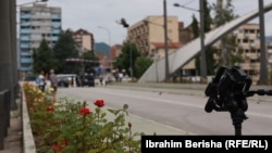 A camera stand sits atop a bridge on the Ibar River, which separates heavily Albanian South Mitrovica from the smaller and mostly Serb North.