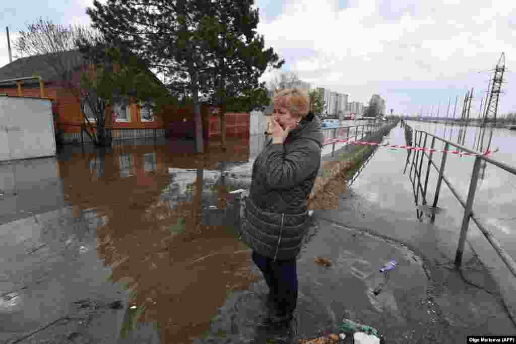Lyudmila Borodina, 56, a medical worker, cries in a flooded residential area of the Russian city of Orenburg on April 13. Flooding in Orenburg became &quot;critical&quot; on April 12, resulting in &quot;mass evacuations&quot; as the Ural River continued to rise. &nbsp;