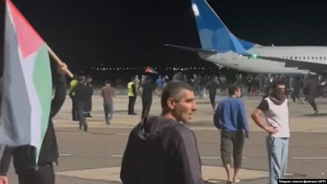Protesters storm the runway of the airport in Makhachkala as a flight arrives from Israel late on October 29. 