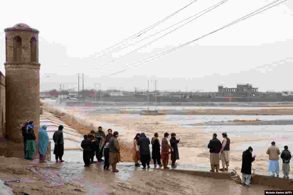 Afghan residents gather near the Pul-i-Malan bridge near the Hari Rud River following the flash floods on the outskirts of Herat on March 12. The flash flood washed away a flood protection dike built three years ago, causing widespread damage to an agricultural area near the border with Turkmenistan.