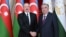 Azerbaijani President Ilham Aliyev (left) and Tajik President Emomali Rahmon shake hands in Dushanbe on September 14.