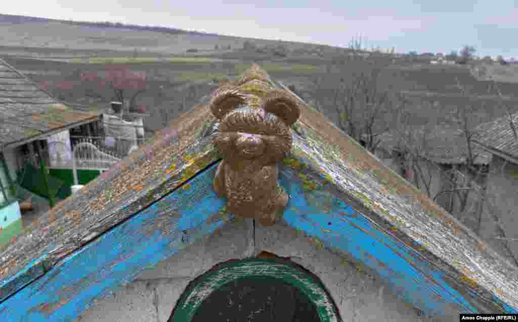 Other houses feature unusual variations on the traditional rooftop theme. In Ferapontievca, the elderly owner of this property says her son visited Moscow when the 1980 Olympics were being held and brought back this &quot;Misha&quot; souvenir from the games. &nbsp;