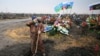 A gravedigger pauses at a cemetery in Russia's Tula region. 