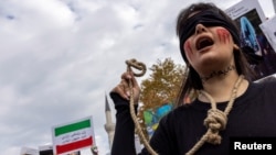 A member of the Iranian community living in Turkey holds a rope during a protest against the death penalty in Iran. (file photo)