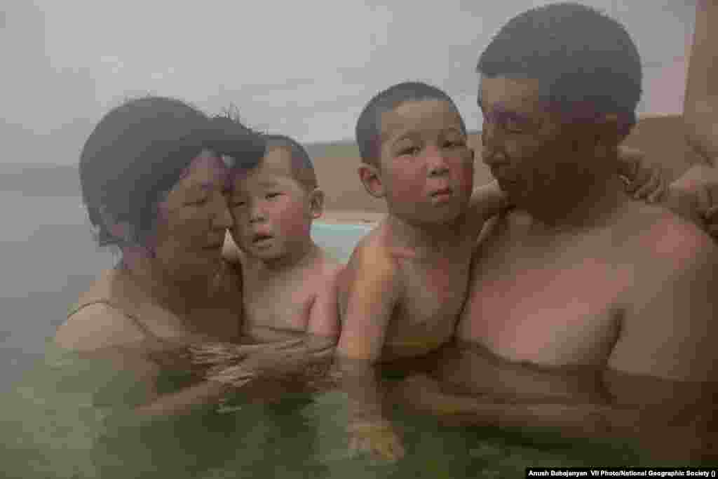 Jaynagul Brjieva and her family enjoy an outing to a hot spring in Kaji-Say, Kyrgyzstan, on March 9, 2021. The waters are thought by some to have healing properties. World Press Photo Long-Term Project Award: Battered Waters by&nbsp;Anush Babajanyan, VII Photo/National Geographic Society &nbsp;