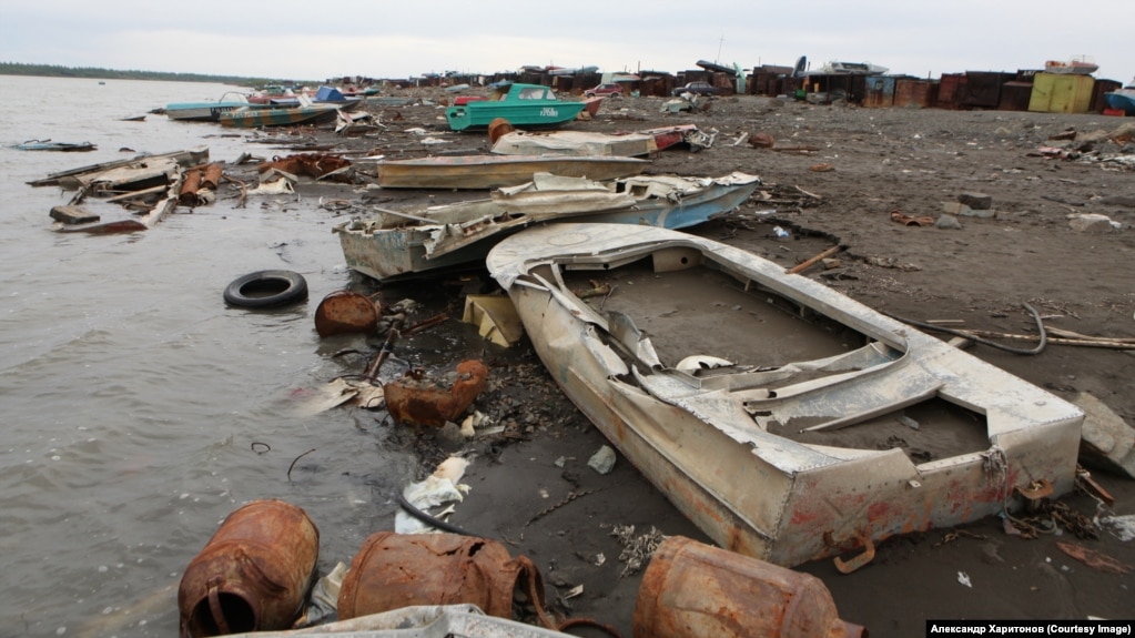 The litter-strewn banks of the Norilsk River.