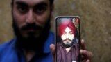Harmindar Sikh shows the photo of his brother Manmohan Singh, reportedly killed by IS-K militants in Peshawar on June 25.