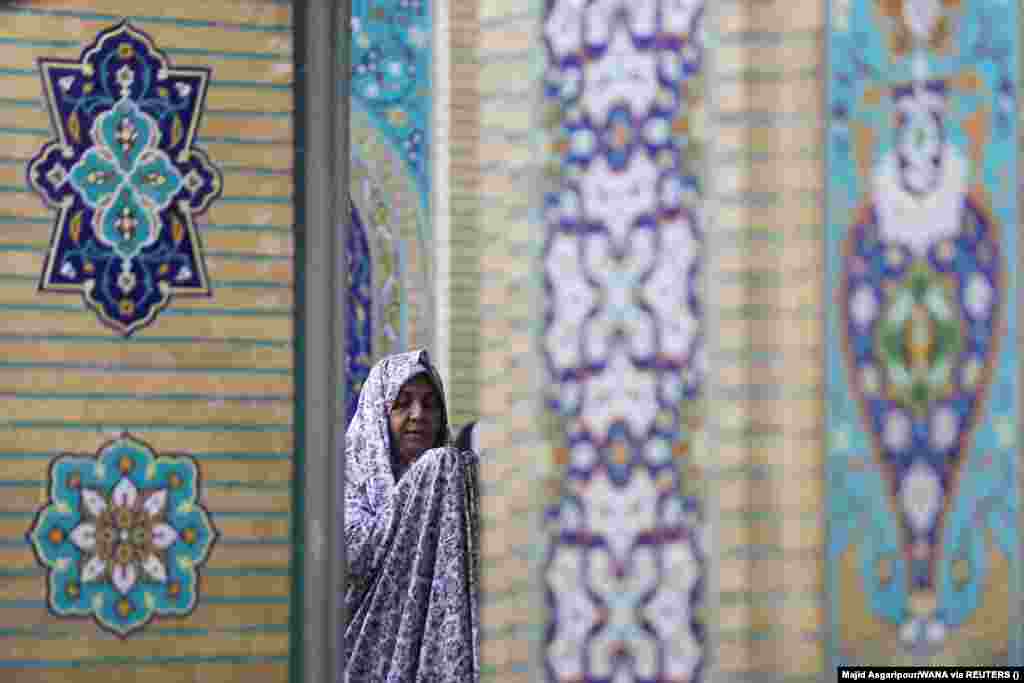 An Iranian woman prays on Eid al-Adha at the shrine of Abdol-Azim in Tehran.