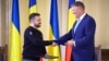 President Ukrainian Volodymyr Zelenskiy and his Romanian counterpart, Klaus Iohannis, shake hands in Bucharest on October 10. 