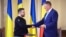 President Ukrainian Volodymyr Zelenskiy and his Romanian counterpart, Klaus Iohannis, shake hands in Bucharest on October 10. 