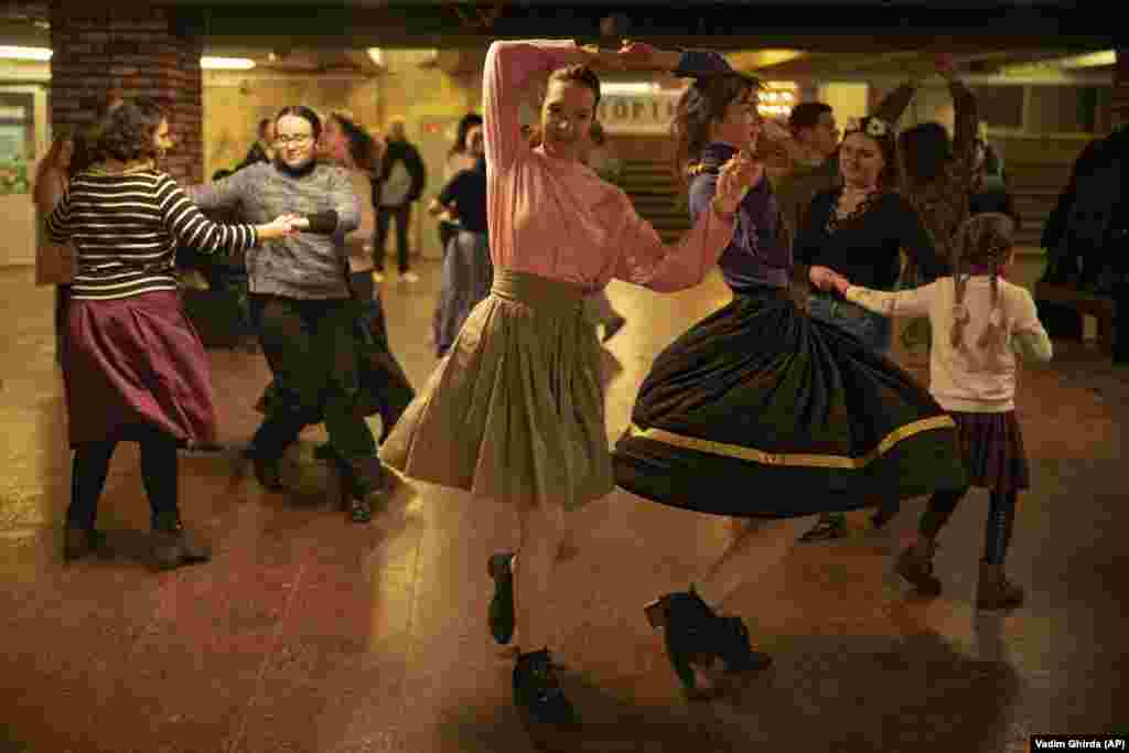People dance in a subway station during an air-raid alarm in Kyiv.