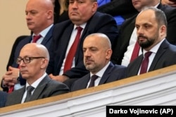 Former Serbian List Vice President and accused attack ringleader Milan Radoicic (center) attends a session of parliament in Belgrade in February 2023.