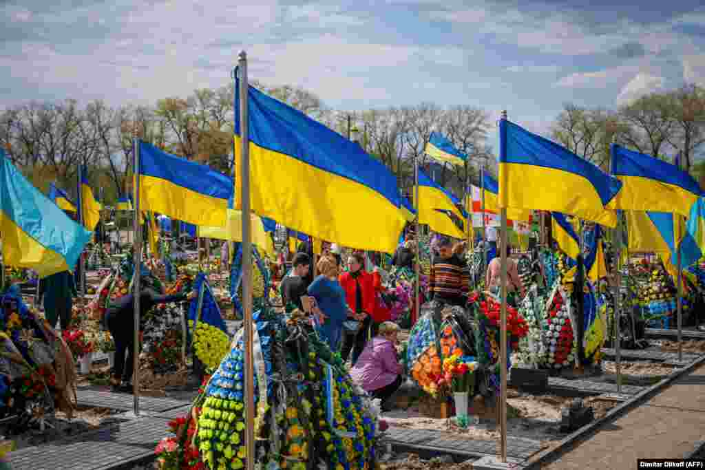 Relatives visit the grave of a Ukrainian soldier in a cemetery in Brovary, just outside Kyiv, in April 2023.&nbsp;