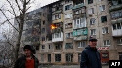 Ndërtesë e djegur në Slloviansk dhe dy banorë lokalë.