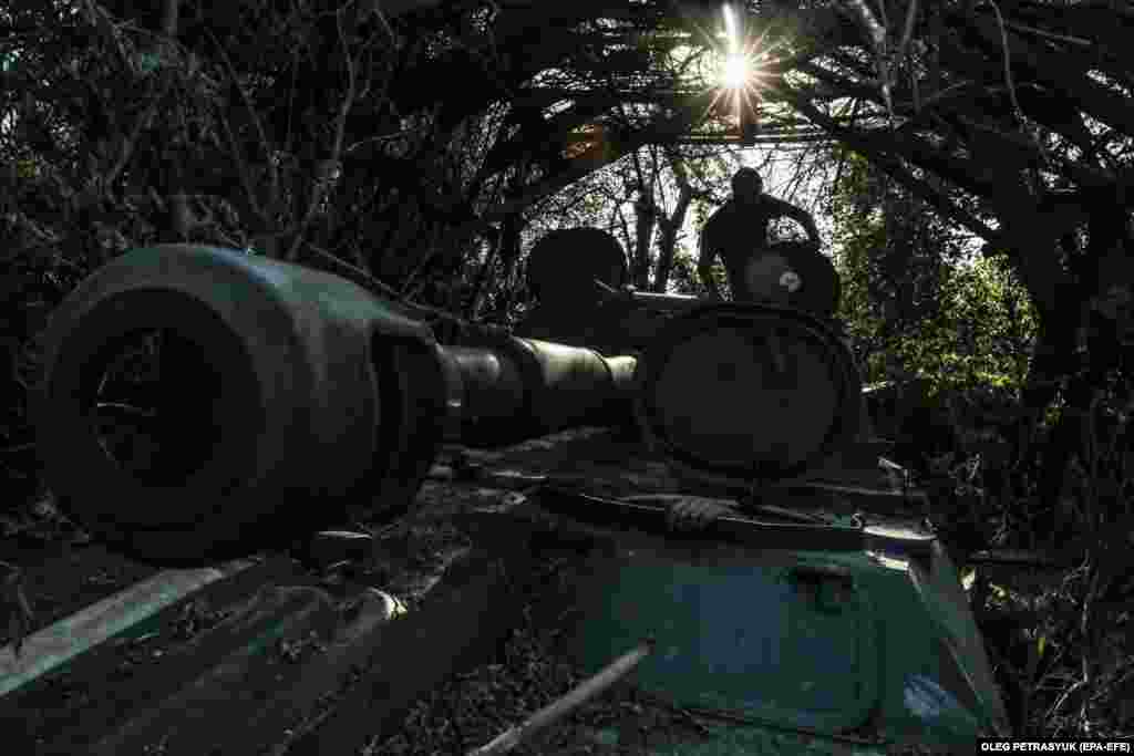 A Ukrainian soldier of the 24th Separate Mechanized Brigade gets out of a 2S1 Gvozdika self-propelled howitzer at an undisclosed location in the Donetsk region, eastern Ukraine.