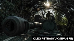 A Ukrainian soldier of the 24th Separate Mechanized Brigade gets out of a 2S1 Gvozdika self-propelled howitzer at an undisclosed location in the Donetsk region, eastern Ukraine, on July 13.