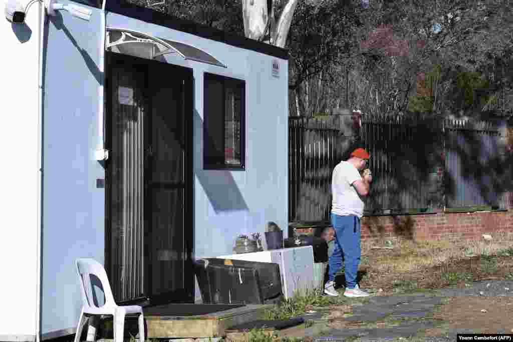 The diplomat smokes a cigarette outside the temporary structure on June 24.&nbsp; Australian police were reportedly unable to remove the official due to his diplomatic immunity.&nbsp; &nbsp;