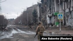 UKRAINE - A Ukrainian serviceman walks an empty street in the front line city of Bakhmut, February 21, 2023.