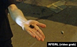 A protester showed a Current Time cameraman what appeared to be rubber projectiles that were allegedly fired during the May 1 demonstration in Tbilisi.
