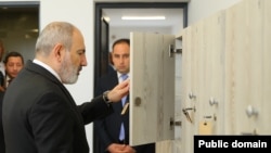 Armenia - Armavir Governor Davit Khudatian (right) looks on as Prime Minister Nikol Pashinyan inspects a newly repaired school in ths region, May 11, 2024.