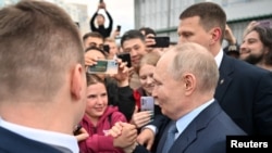 Russian President Vladimir Putin greets people in Yakutsk on June 18.