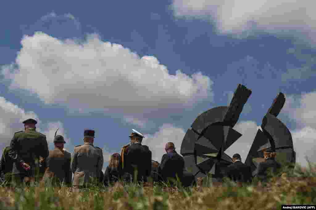 Officers from foreign armed forces, local state representatives, and other attendees take part in a memorial service during Holocaust Remembrance Day in Belgrade.