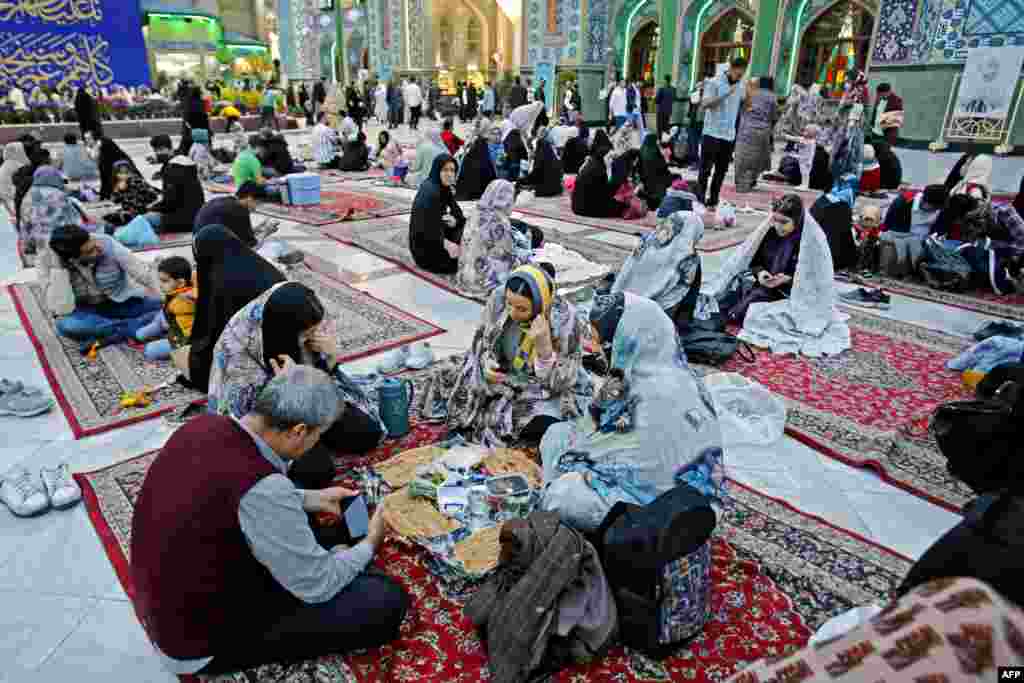 Iranian families gather to break their fast during the first week of the holy month of Ramadan at the Emamzadeh Saleh in Tehran.