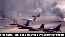 US F-15 and F-16 jets fly over burning oil fields during Desert Storm in 1991.
