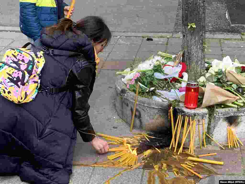 Serbia - Citizens light candles and leave flowers in front of the school