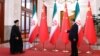 ابراهیم رئیسی (چپ) رئیس‌جمهور اسلامی ایران در سفر بهمن‌ماه پارسال خود به پکن مورد استقبال شی جین‌پینگ، همتای چینی‌اش، قرار گرفت
