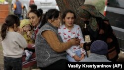 Ethnic Armenians from Nagorno-Karabakh comfort a young woman upon arriving in Kornidzor in Armenia's Syunik region.