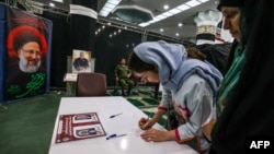 Iranian women prepare to cast their ballots at a polling station in Tehran on July 5.