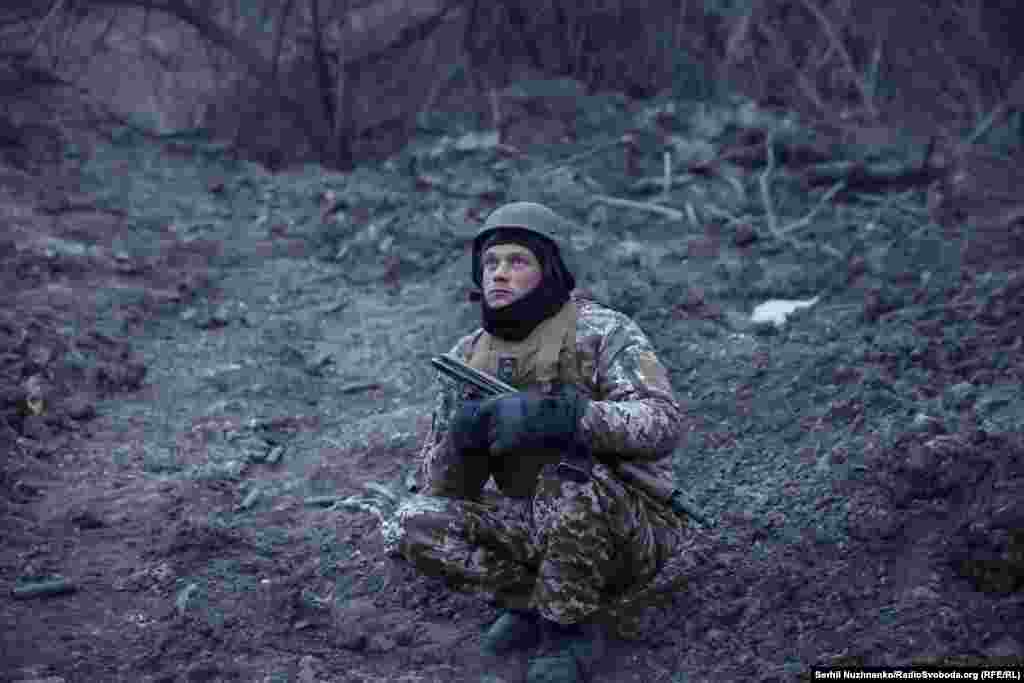 A soldier watches for Russian drones before moving positions.