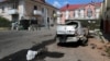 Buildings and a vehicle damaged from attacks in Shebekino earlier this month.