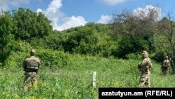 Armenia - Masked security officers guard a new border post placed in Kirants,
May 20, 2024.