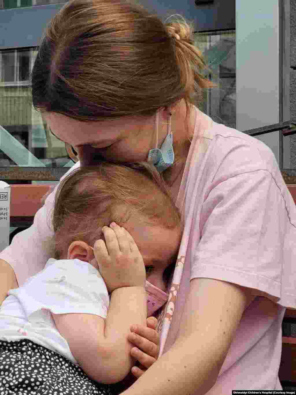 A woman comforts a child outside the Okhmatdyt hospital after the July 8 strike. The Kremlin has claimed a wayward Ukrainian air-defense missile was to blame for the explosion in the hospital grounds, but images captured of the projectile show the distinctive silhouette of a Kh-101 cruise missile, a weapon used exclusively by the Russian military. Ukrainian authorities claim the missile hit &ldquo;the exact target it was programmed for&rdquo; amid a wave of Russian strikes across Ukraine that day.&nbsp;