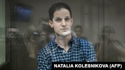 U.S. journalist Evan Gershkovich stands inside a defendants' cage before a hearing at the Moscow City Court on April 18, 2023. 